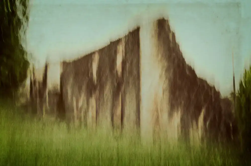 A vast, painterly cinematic landscape showing a mysterious ruined castle
