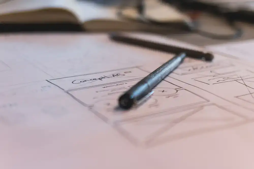 Concept art and storyboards scattered across a studio desk